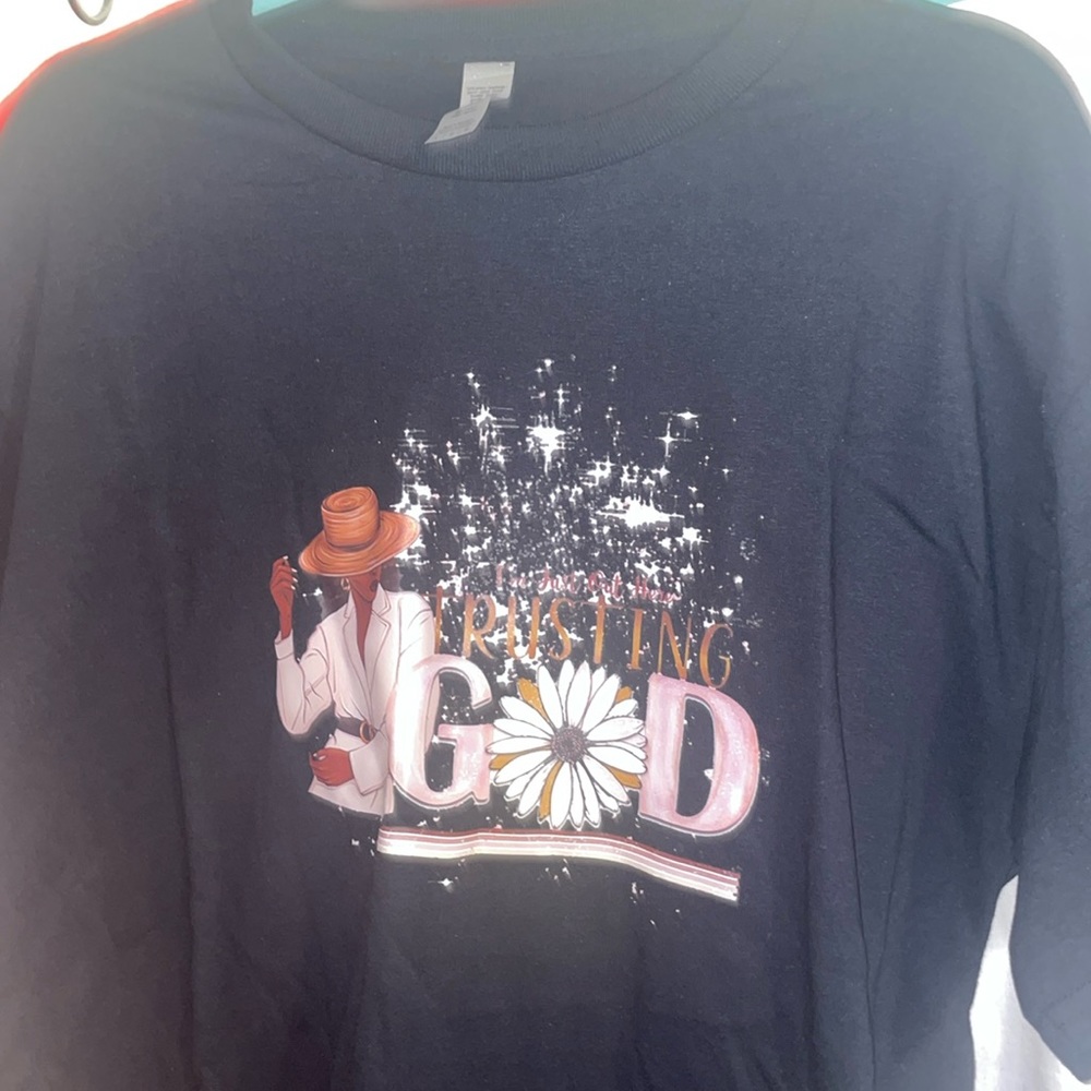 A large, black, “I’m just trusting God” woman’s t-shirt.